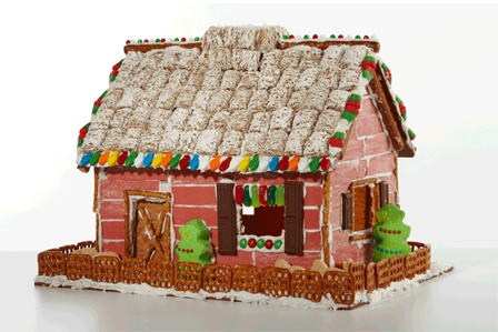 An antique holiday barn gingerbread house creation